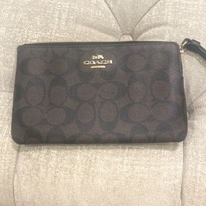 Wristlet by coach this black and brown color is‎ sized at 8 “ (L) x  5 “ …